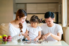 Family countin gchange on teh coffee table.