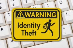 Keyboard with and identity theft sign on top of keys