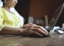 Lady typing on computer keyboard